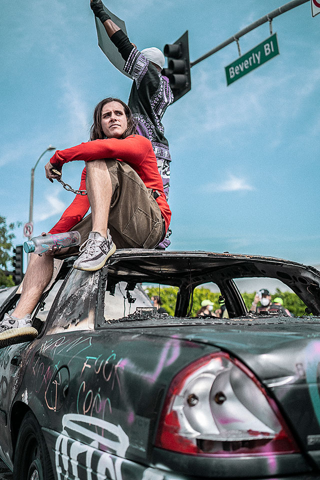 Dude on Burnt Out Police Car, Los Angeles, May 30, 2020 Dude on Burnt Out Police Car, Los Angeles, May 30, 2020