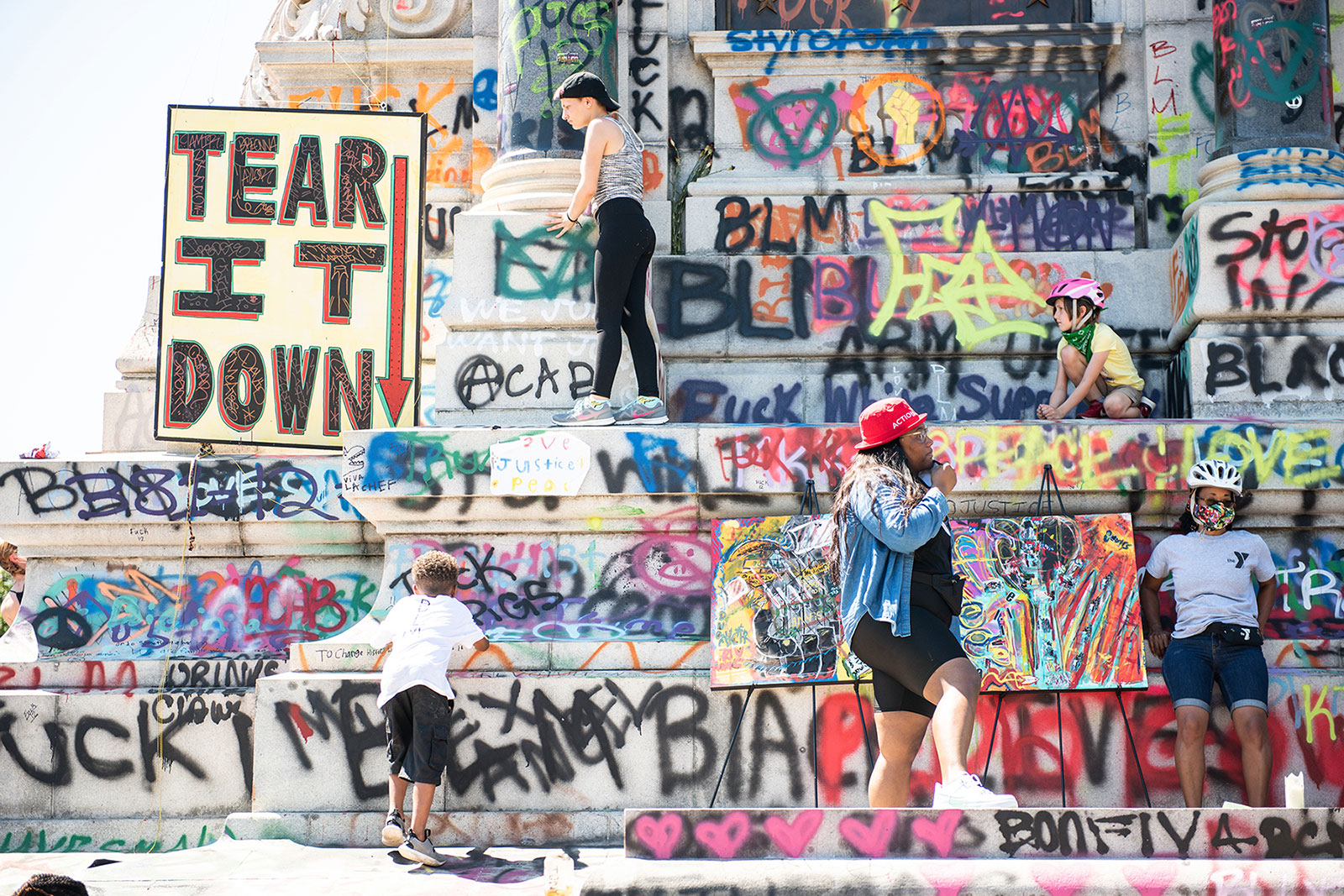 Visitors climb on the graffitied steps of the Robert E. Lee Monument. In recent months, the area has seen a dramatic increase of people coming specifically to experience the monument. Photo by <a href="https://evergib.com/">EVERGIB.</a> Visitors climb on the graffitied steps of the Robert E. Lee Monument. In recent months, the area has seen a dramatic increase of people coming specifically to experience the monument. Photo by <a href="https://evergib.com/">EVERGIB.</a>