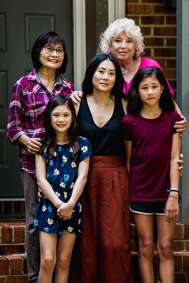 Laura Pho's family is an example of intergenerational living, choosing to quarantine together. Laura (center) is flanked by her two daughters, her mother (left) and mother-in-law (right). Not long after this photo was taken, Laura's mother, Lucy Le, died unexpectedly. As part of their Buddhist faith, the family is honoring her in a 49-day mourning ritual. Photo by <a href="https://www.taniadelcarmen.com/">Tania del Carmen Fernández.</a> Laura